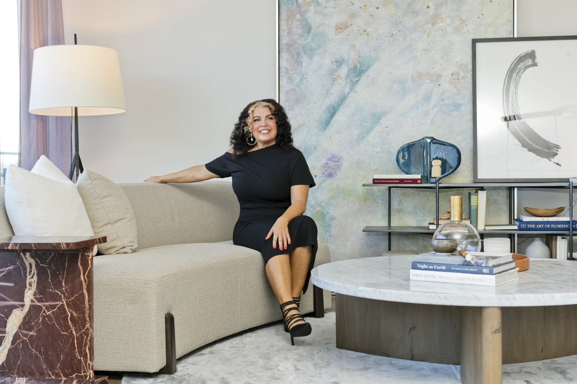 Katina Benenate seated in an art-filled living room