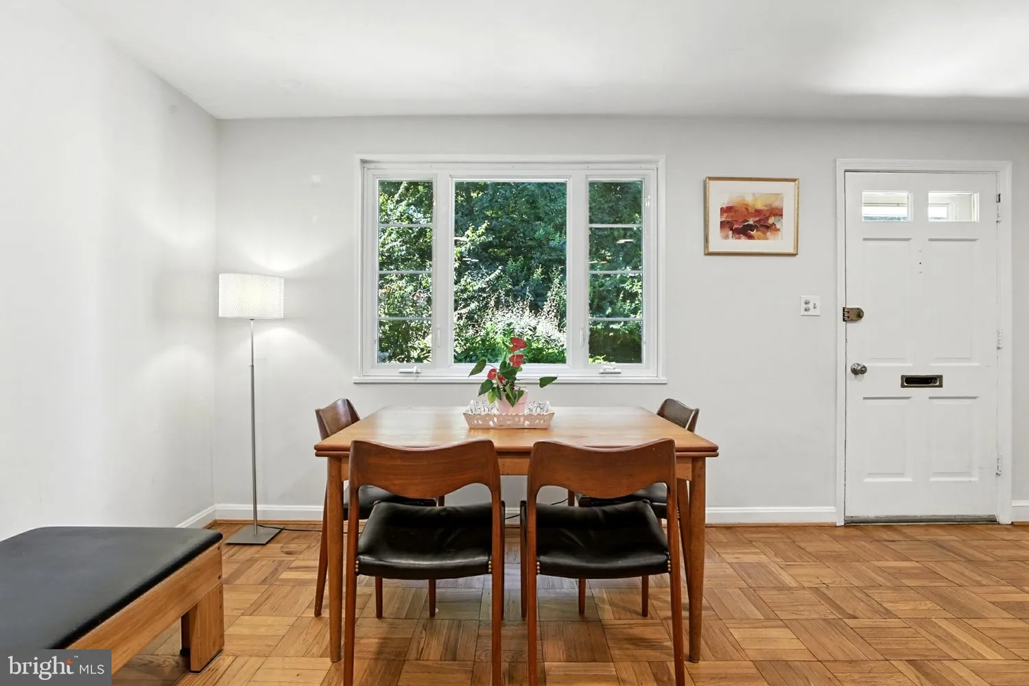 Dining area with a wood table, four chairs, and organic views