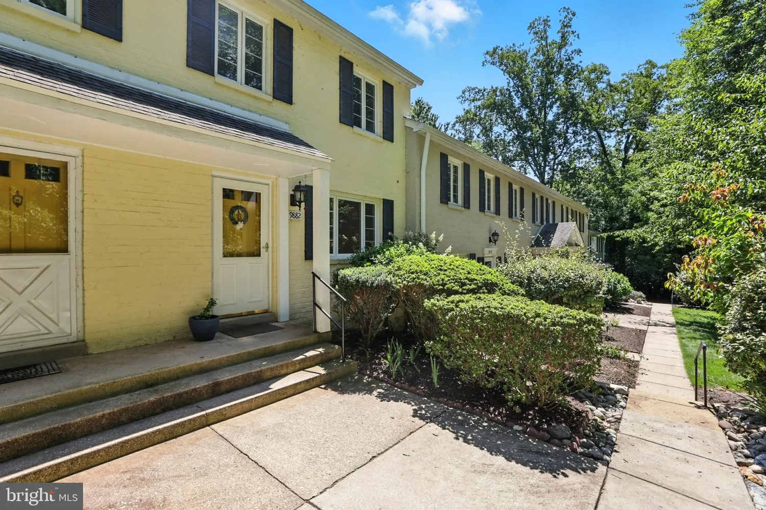 Front entry of the brick townhouse at 9882 Hollow Glen Place