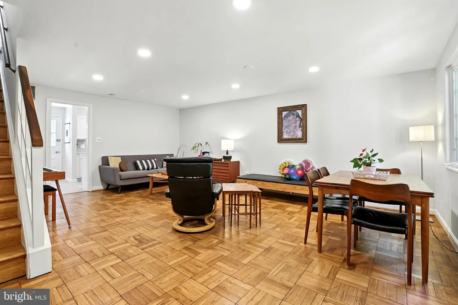 Bright living and dining area with parquet hardwood flooring