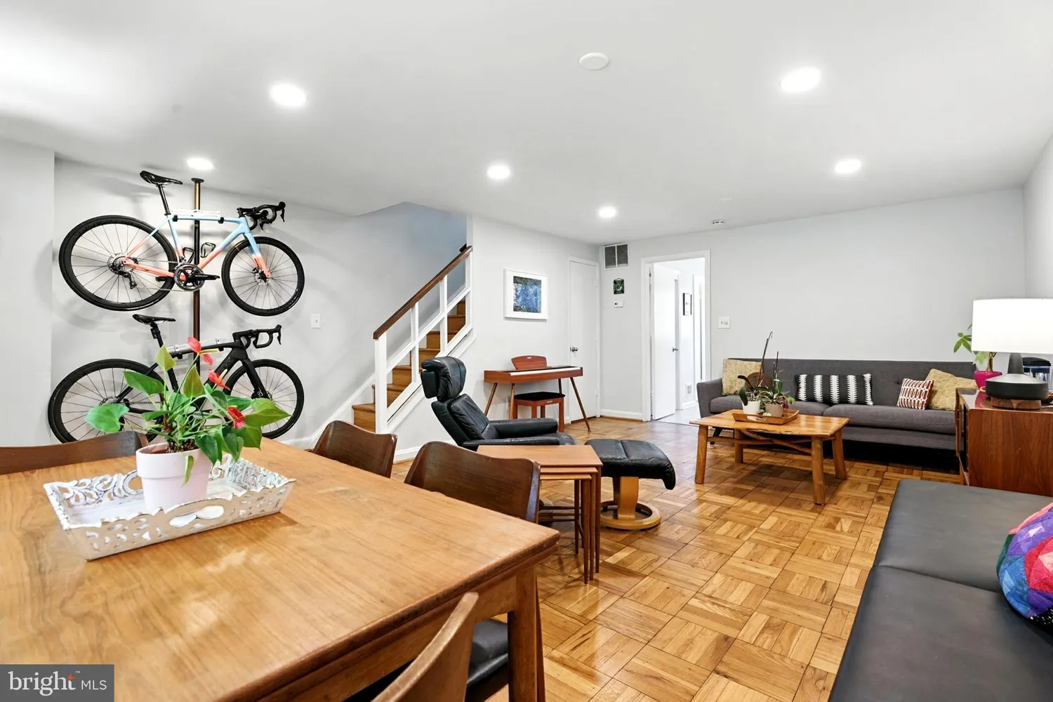 Spacious main-floor living and dining area with parquet hardwood flooring